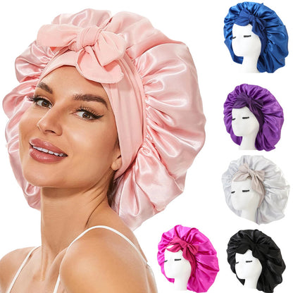 Woman wearing a pink satin bonnet with additional bonnets in different colors displayed on mannequins.